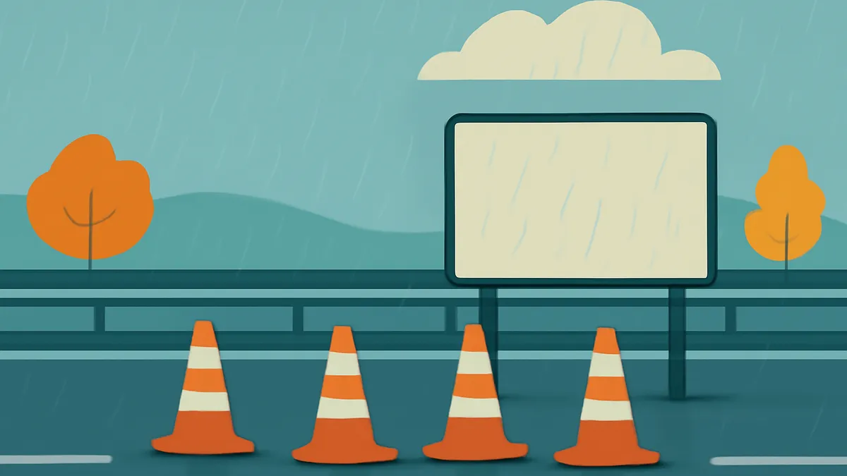 Four orange and white traffic cones on a wet road with a blank billboard and two orange trees under a cloudy sky