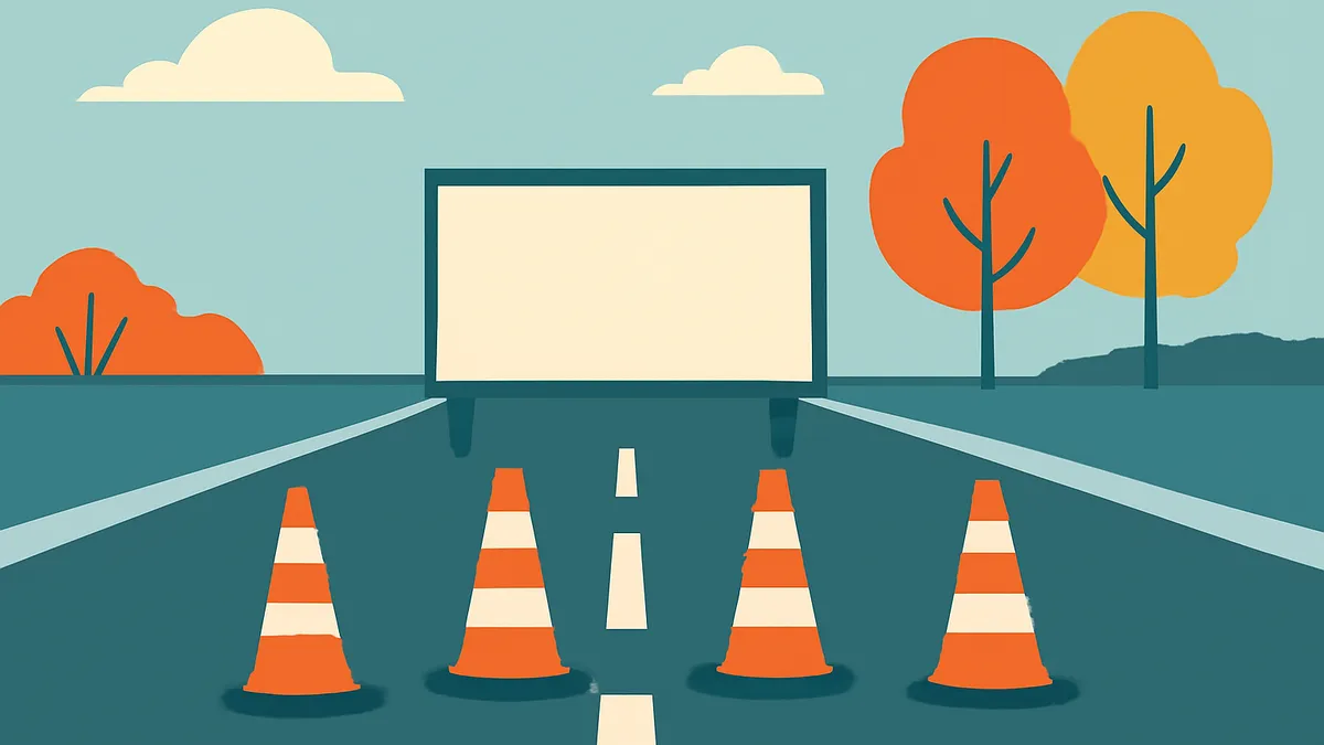 A highway scene with a large blank billboard, four orange and white traffic cones, and trees under a blue sky