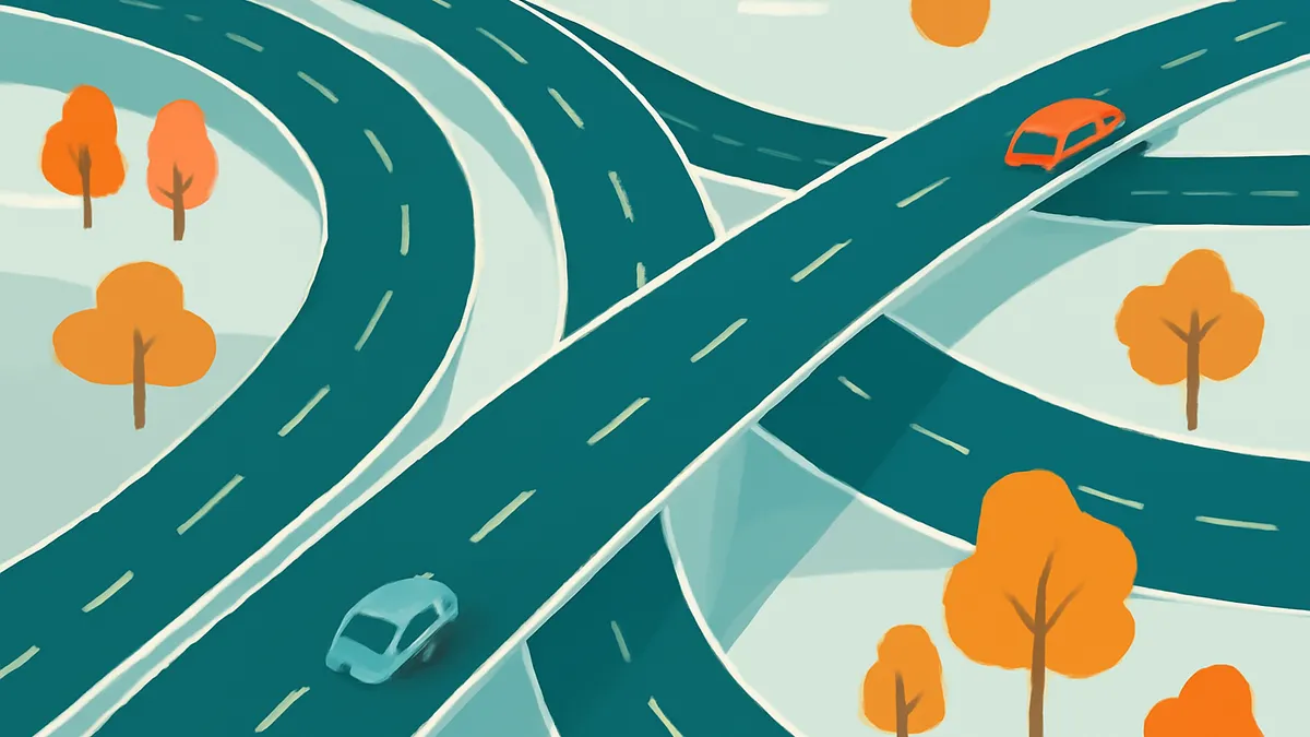 An overhead view of a complex highway interchange with multiple roads curving and crossing, with two cars and several trees