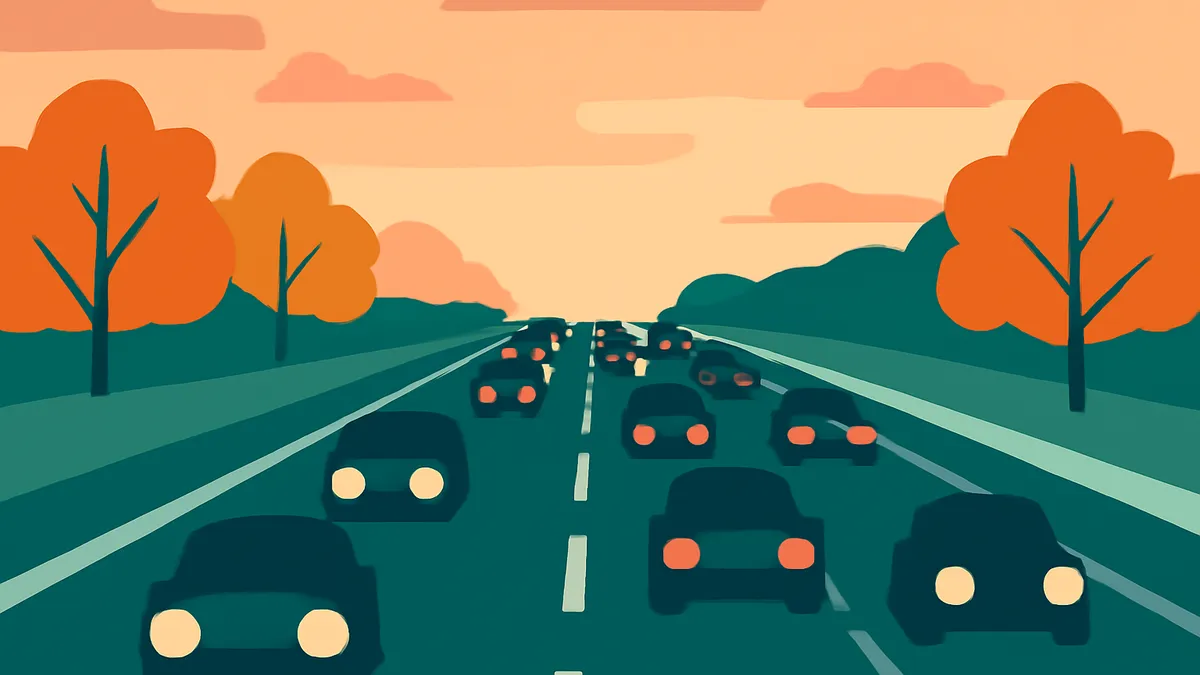 A highway with many cars driving in both directions, with trees on either side, under an orange sky