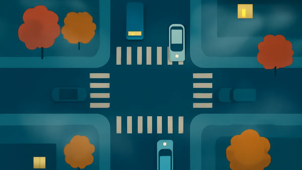 An overhead view of a city intersection at night, with four cars, four trees, and two buildings with lit windows