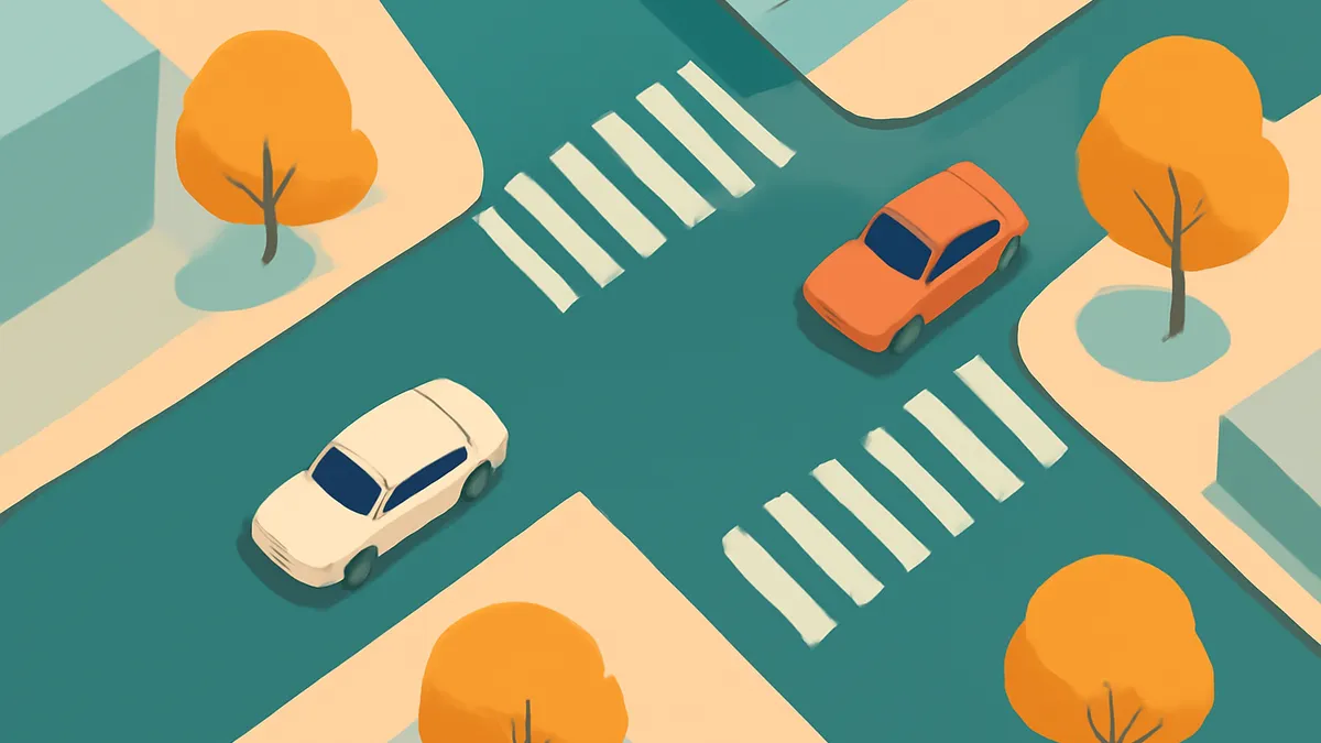 An overhead view of a city intersection with two cars, one orange and one white, on a teal road