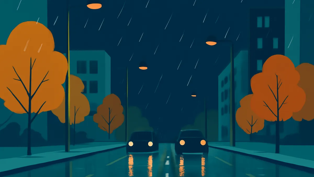 Two cars with headlights on drive on a wet road at night, with trees and buildings in the background