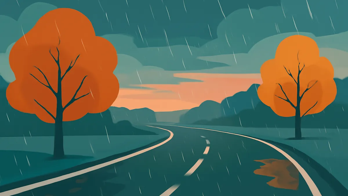 A winding road with white lines, flanked by two orange-leafed trees, under a rainy sky with a sunset glow
