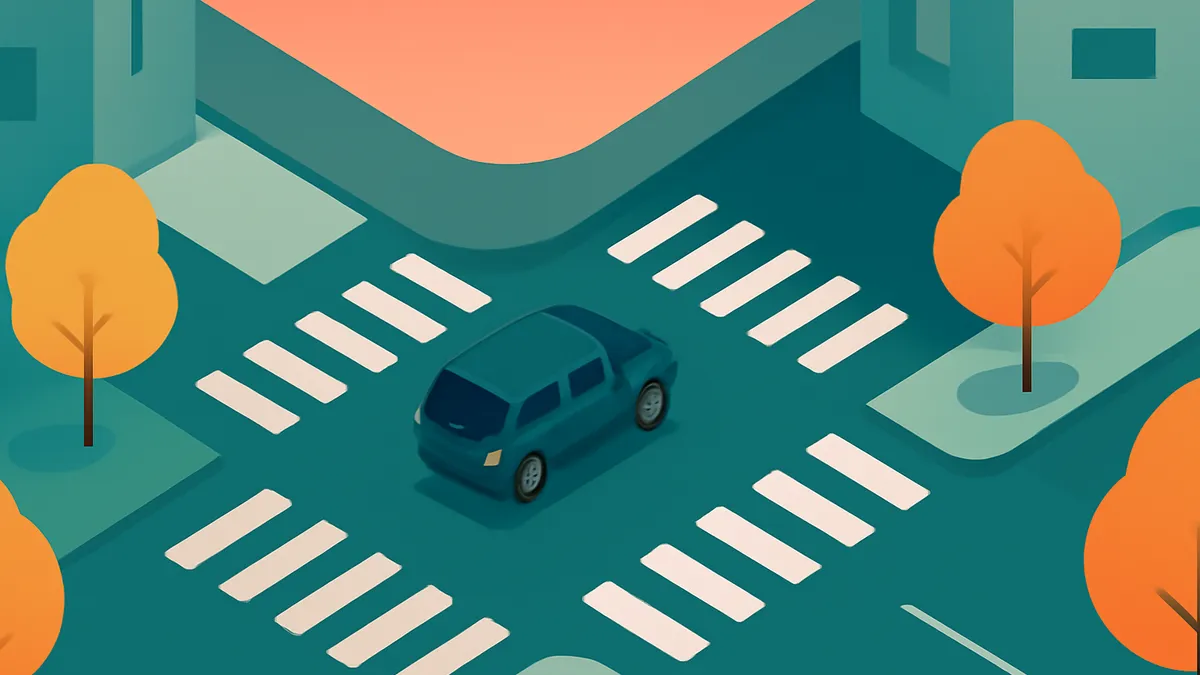 A teal car at a crosswalk in a city with orange trees and buildings