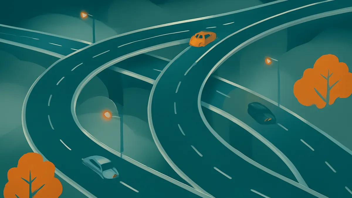 An overhead view of a complex highway interchange with multiple curving roads, streetlights, and three cars