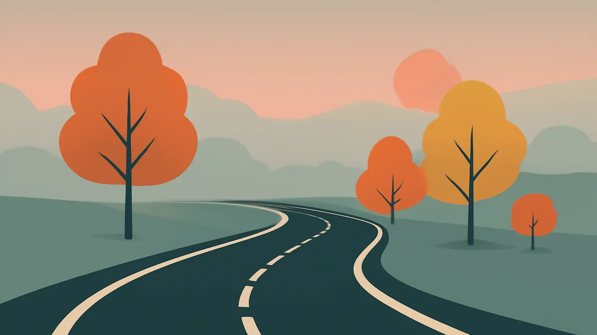 A winding road with white lines through a landscape with trees and hills under a pink sky