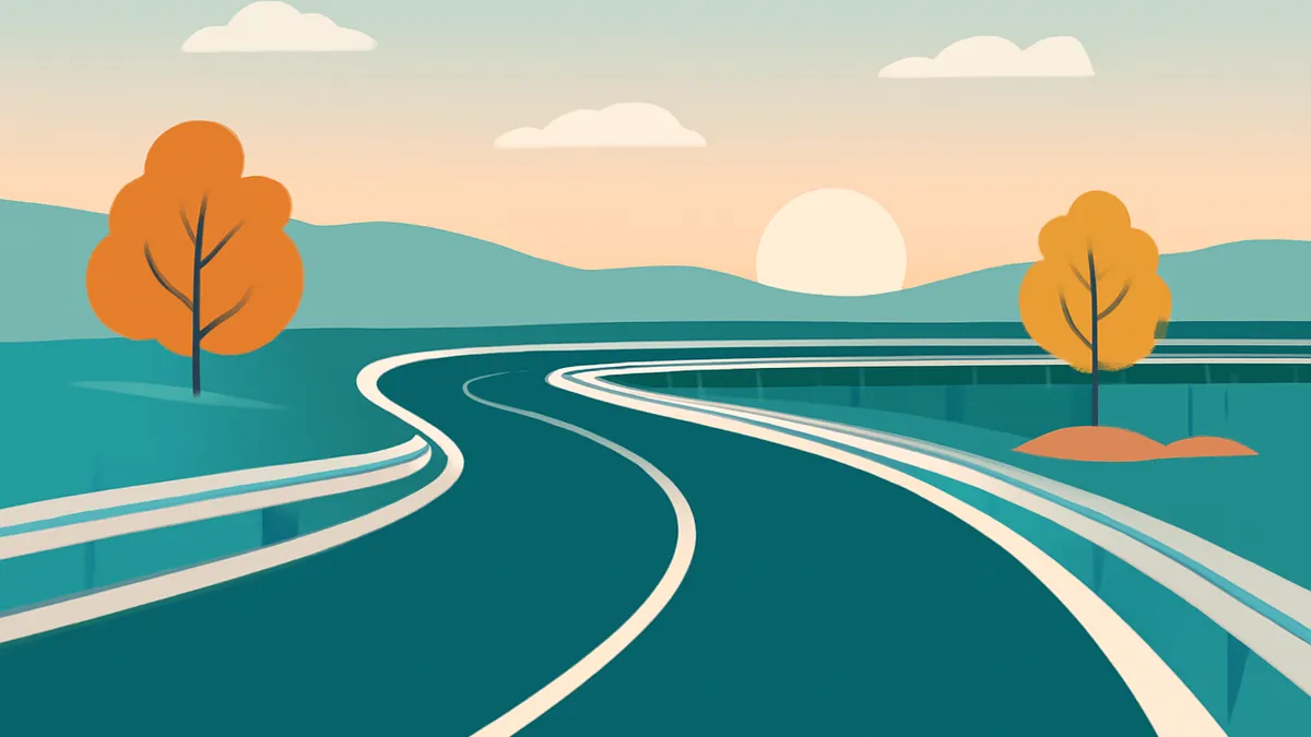A winding road with white lines, two trees with orange leaves, and mountains under a sunset sky