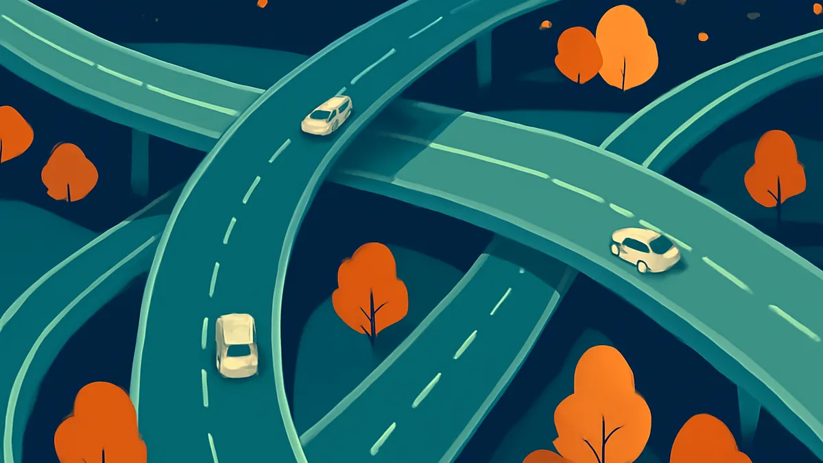 An overhead view of a complex highway interchange with multiple cars on the roads, surrounded by trees