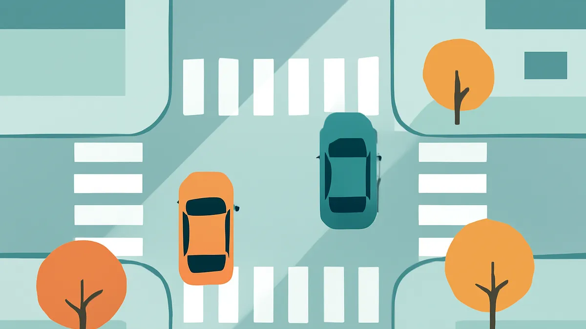An overhead view of two cars, one orange and one teal, at a crosswalk on a light blue road with trees