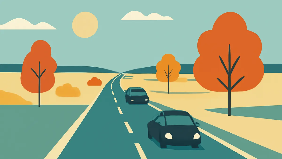 Two cars on a winding road through a landscape with trees and hills under a sunny sky