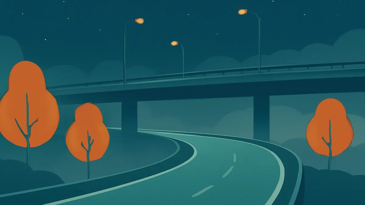 A highway underpass at night with a curving road and three orange trees under streetlights
