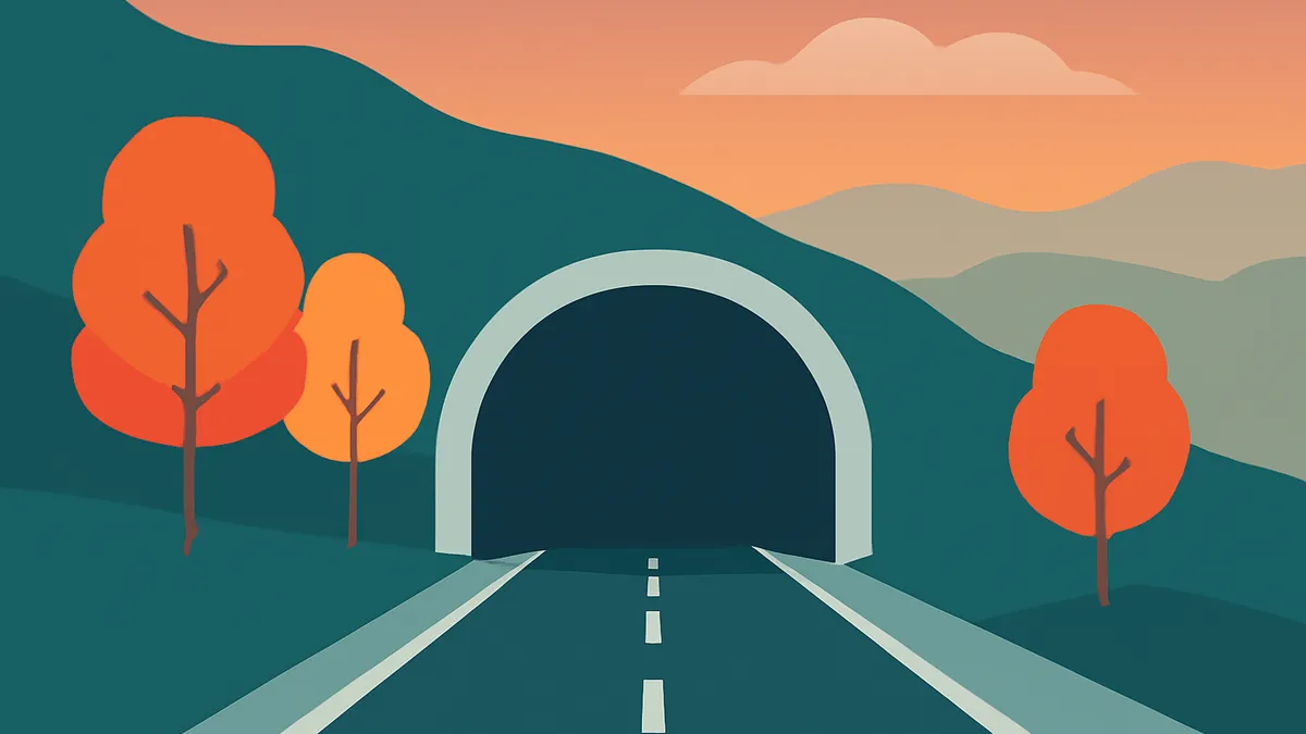 A road leading into a tunnel, flanked by hills and autumn trees under an orange sky with a single cloud